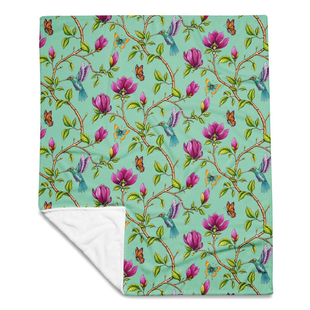 Magnolia Dreams throw blanket in Vista Blue, featuring pink magnolia blossoms, colorful hummingbirds, butterflies and green leaves
