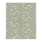 Magnolia Dreams Gilded Garden throw blanket in Turquoise & Gold, featuring golden magnolia blossoms, hummingbirds, butterflies and delicate branches