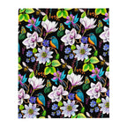 Garden of Eden throw blanket showing its colorful floral pattern with kingfishers, exotic flowers, bumblebees, butterflies and green leaves on a black background