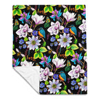 Garden of Eden throw blanket showing the full colorful floral pattern with exotic flowers, kingfishers, butterflies, bumblebees and green leaves on a black background