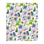Garden of Eden throw blanket displaying a colorful pattern of exotic flowers, kingfishers, bumblebees, butterflies and lush green leaves