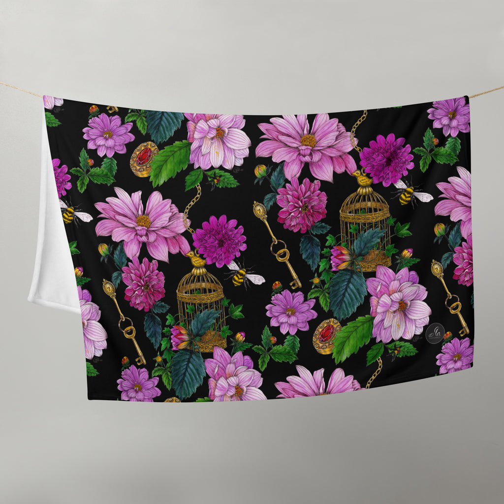 Dahlia Garden throw blanket hanging outdoors, showcasing its colorful floral pattern of flowers, leaves and birdcages