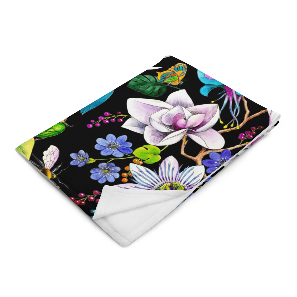 Folded Garden of Eden throw blanket featuring an exotic kingfisher, magnolia flowers, colorful leaves and berries