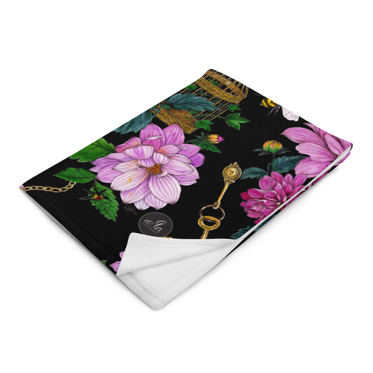 Folded throw blanket featuring the Dahlia Garden floral pattern, shown from above on a light wooden surface