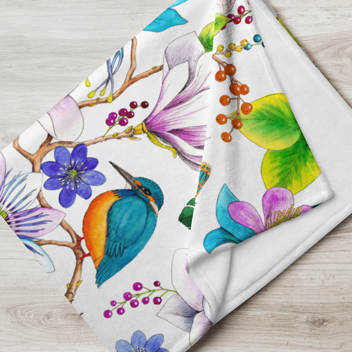 Close-up of a Garden of Eden throw blanket featuring an exotic kingfisher surrounded by colorful flowers and leaves