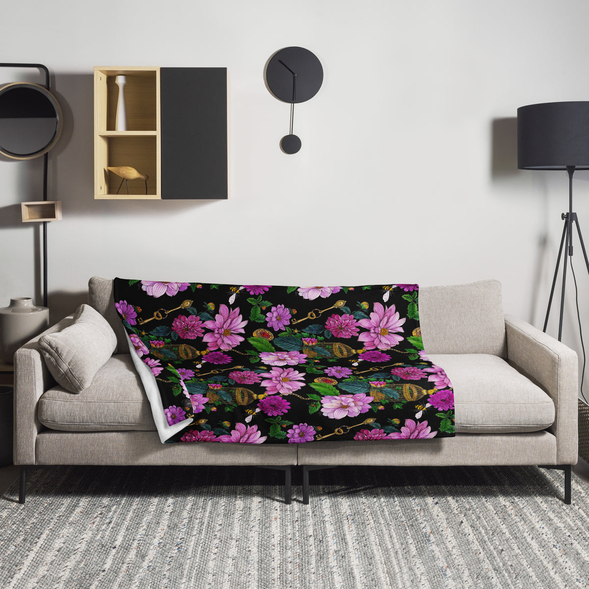 Floral throw blanket featuring the Dahlia Garden pattern, draped over a sofa
