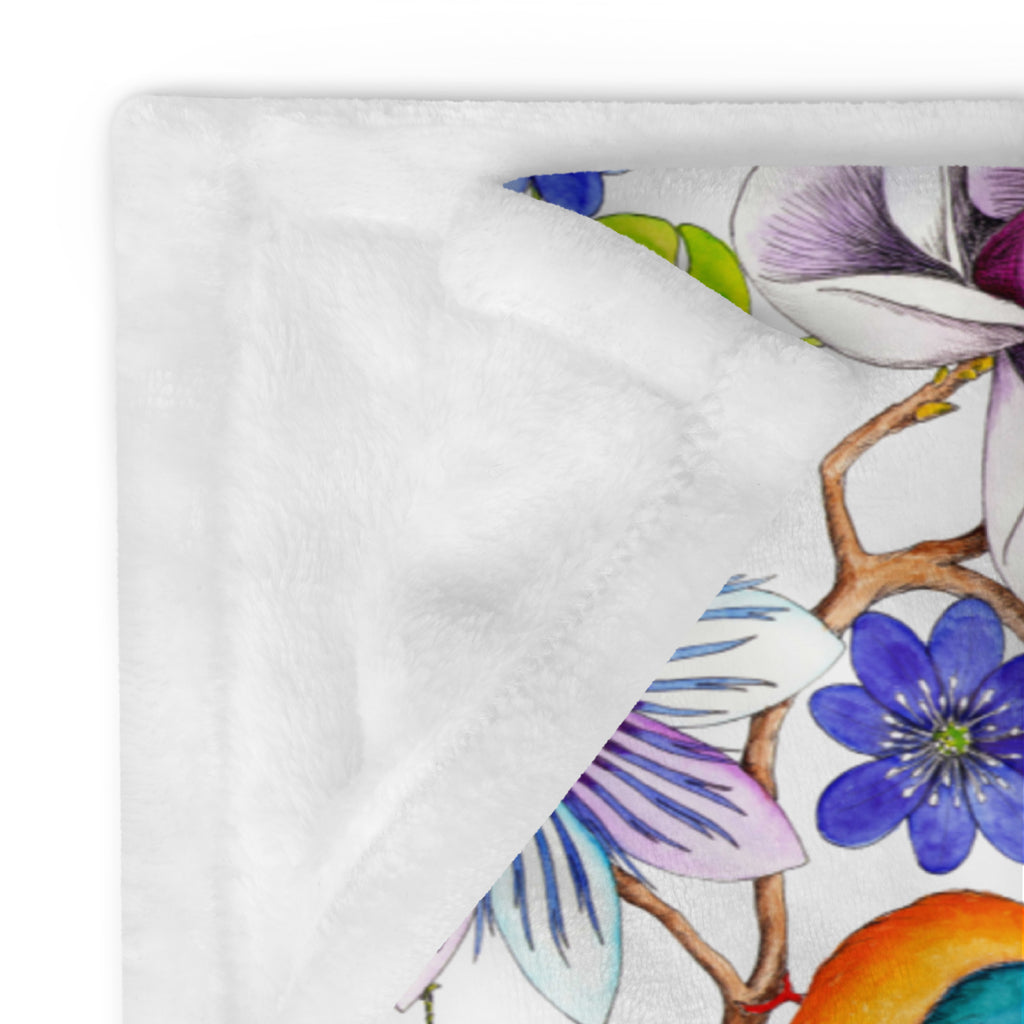 Close-up of a throw blanket featuring the Garden of Eden pattern with exotic flowers, a kingfisher and a bumblebee 