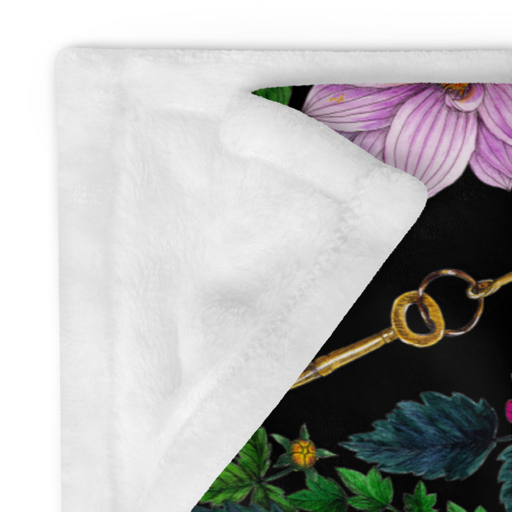 Close-up of a soft throw blanket featuring the Dahlia Garden floral pattern